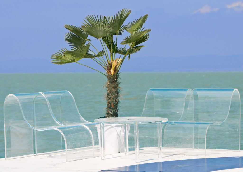 exclusive seating area with a palm tree on the beach