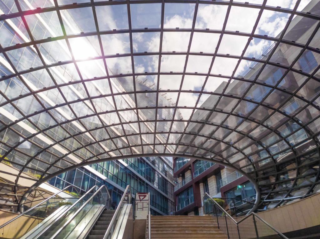 Web-like glass roof - shell-like structure covering the escalator and stairs of a modern office and residential building complex. Atlas Capital Plaza in Podgorica, Montenegro, Jul 24.2019.
