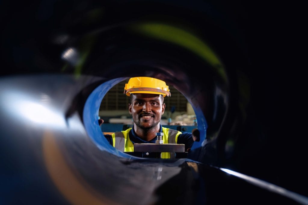 Engineer operator portrait smiling looking through steel roll